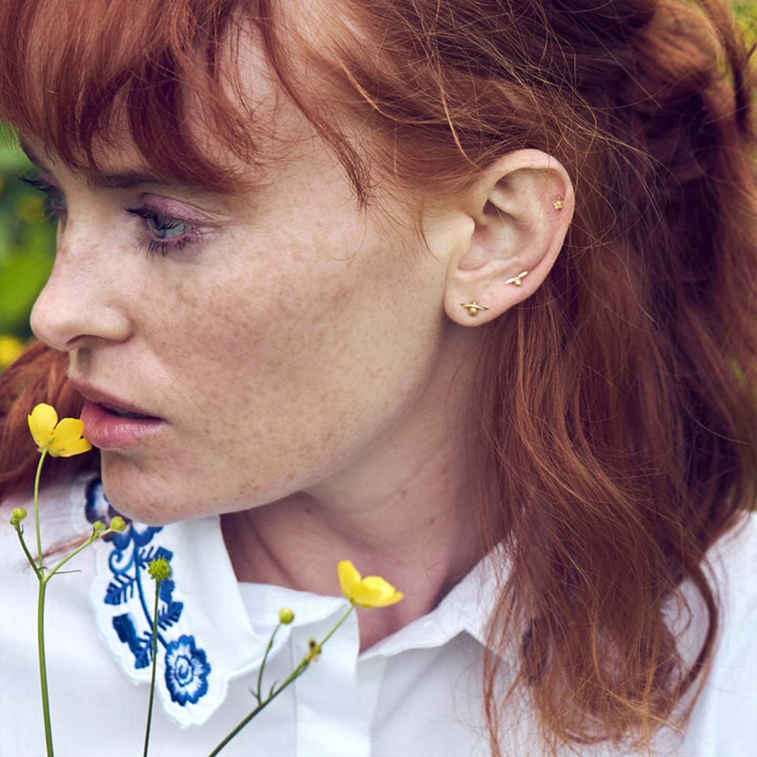 Model wearing Teeny Weeny Bee and Itsy Bitsy Single Stud Earrings by Alex Monroe Fine Jewellery