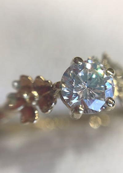 Large blue and green one of a kind bespoke ring being polished at the jewellers bench.