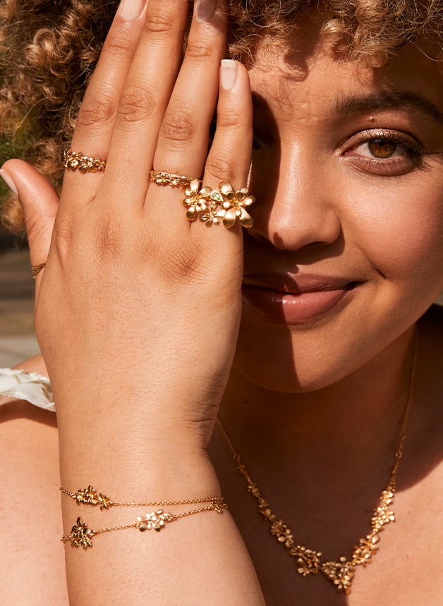 Model wearing period Clustered Rosette Prosper Ring with Teardrop Peridot from the Humble Beginnings collection