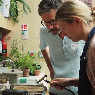 Alex teaching a jewellery school class attendee at the forge.