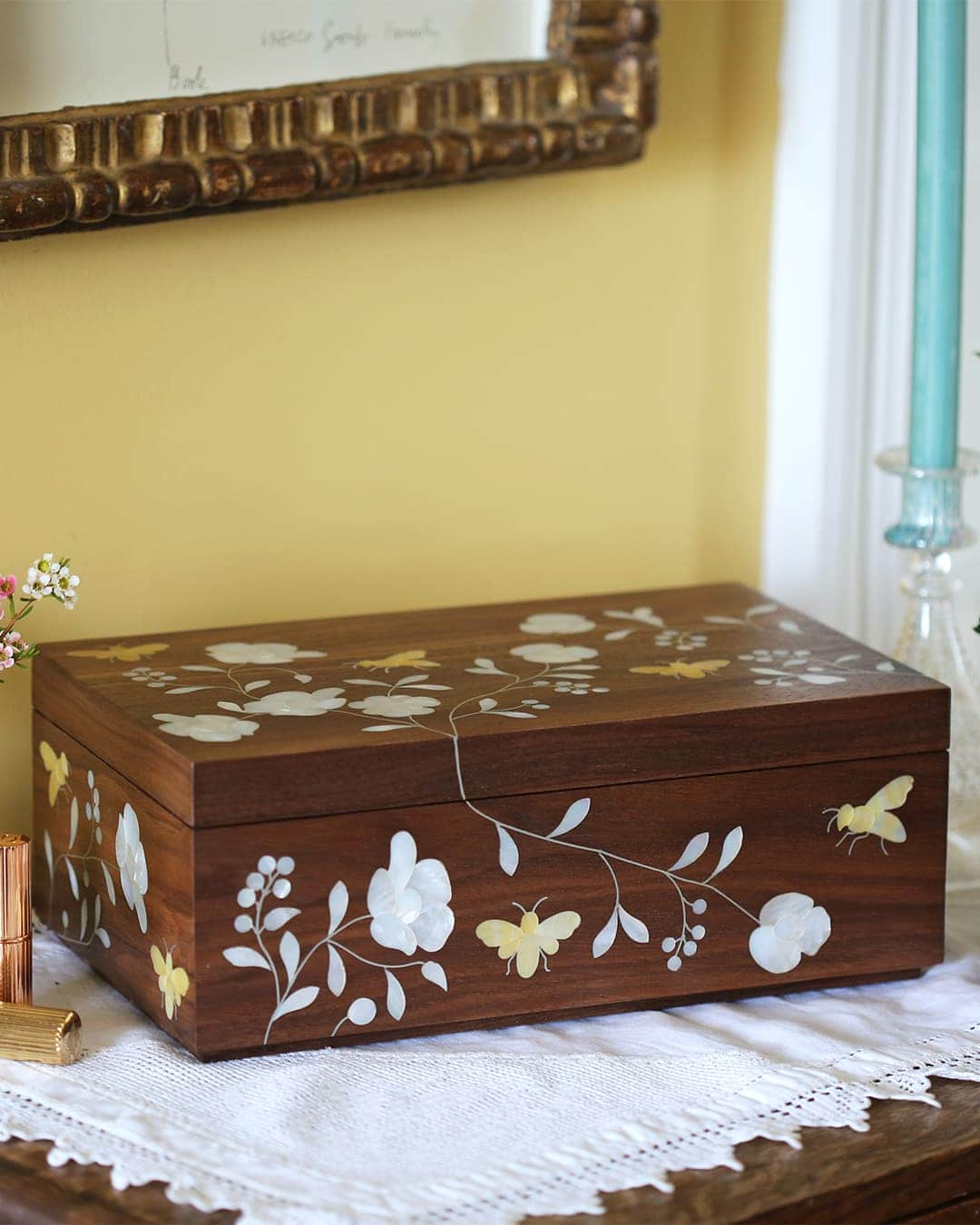 Bees in Bloom Heirloom Jewellery Box on sideboard with candlestick, flowers and makeup.