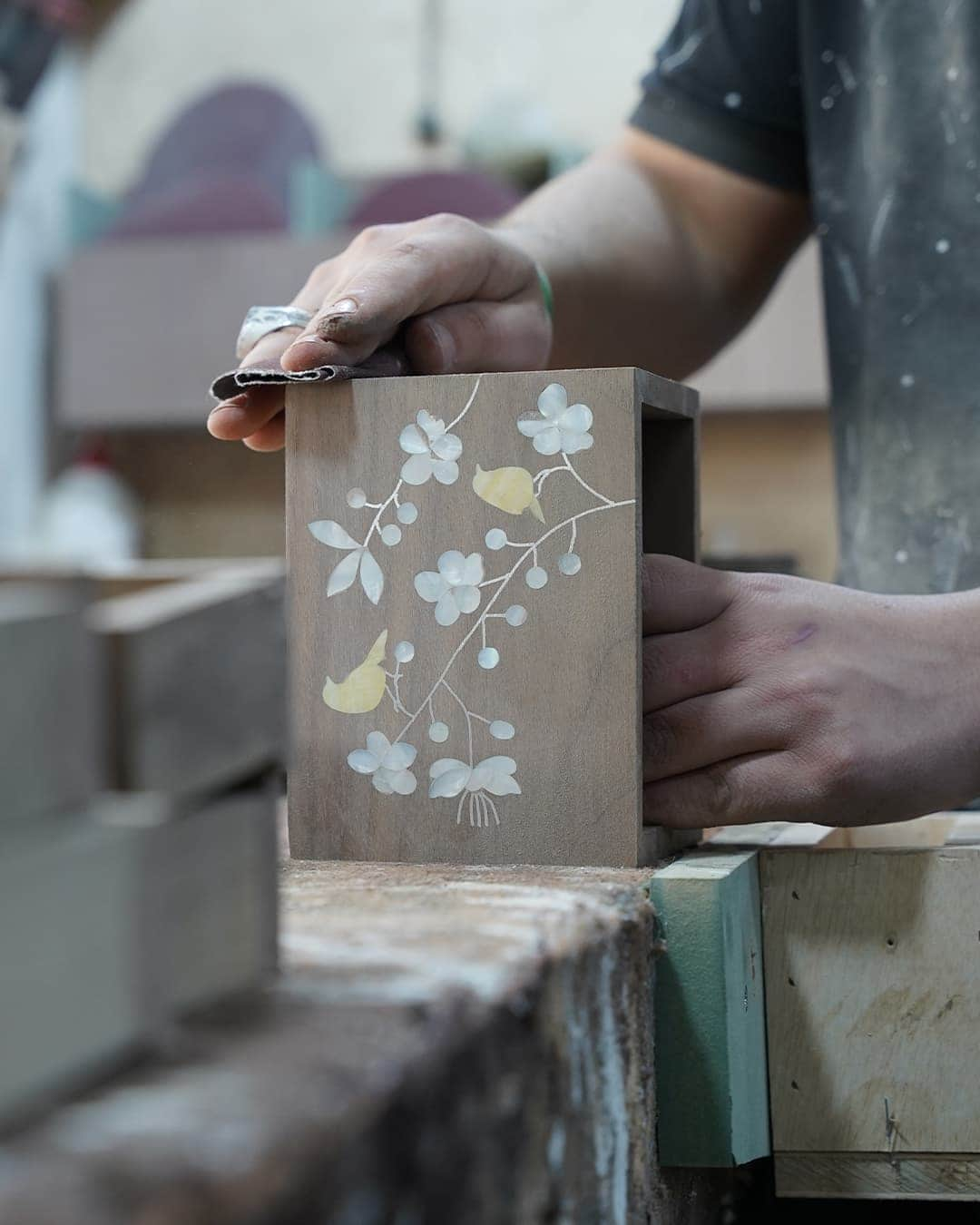 Carefully sanding the boxes.